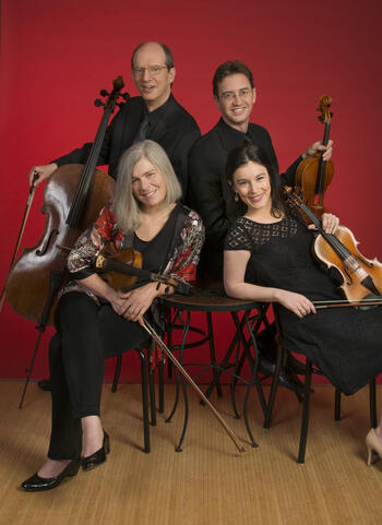 string quartet members with instruments