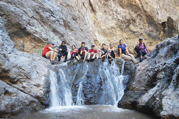 Students sitting at top of waterfall