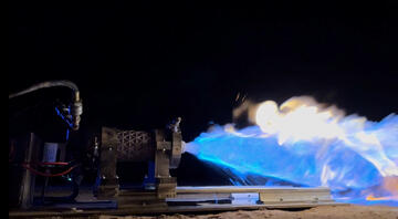 A rocket's liquid bi-propellant engine with fire shooting out.