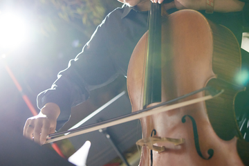 A closeup of a cello player.