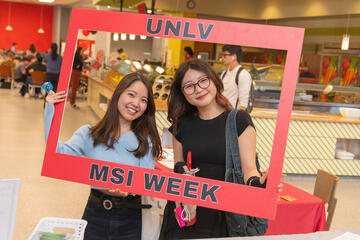 two female students hold frame that reads UNLV MSI Week