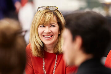 smiling woman wearing glasses on her head