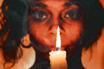 A woman holding a candle.