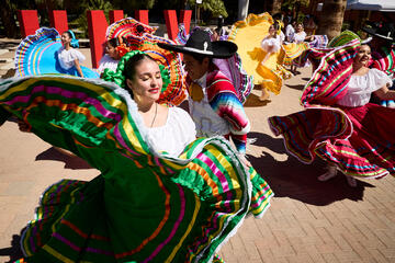 flamenco dancers outdoors with large UNLV letters in background