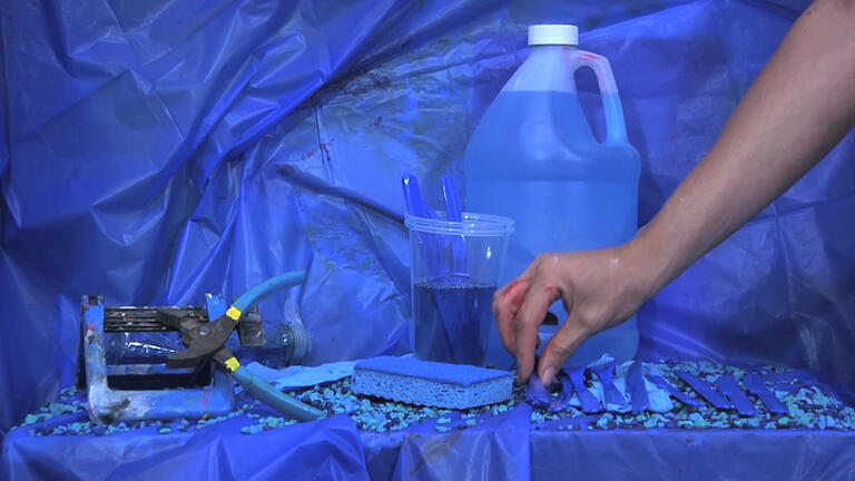 Blue table featuring various blue tools and liquids set against a blue background. Ash Ferlito and Matt Taber, Breakfast in America, 2012, Video