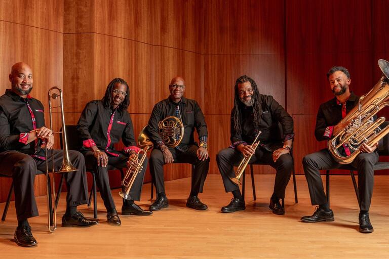 A promotional photo of the Gateways Brass Collective. The artists are holding their instruments.