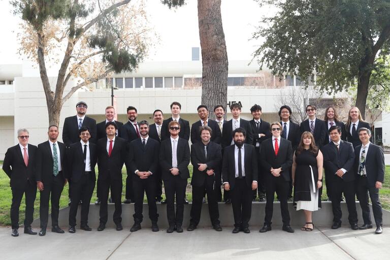 The UNLV Jazz Ensemble I stands outside the Artemus W. Ham Concert Hall for this promotional photo.