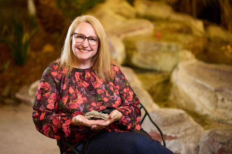 Portrait of Kara Peterson holding a rock.