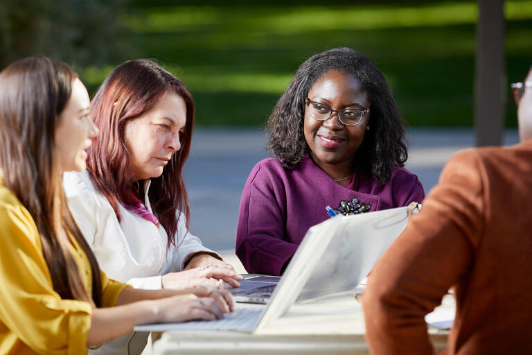 group of women at table looking at computer