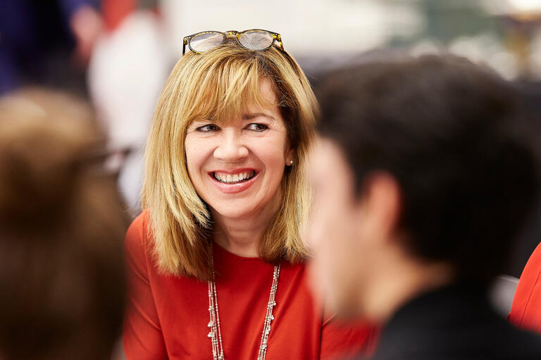 smiling woman wearing glasses on her head