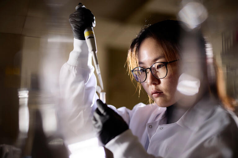 female student using lab equipment