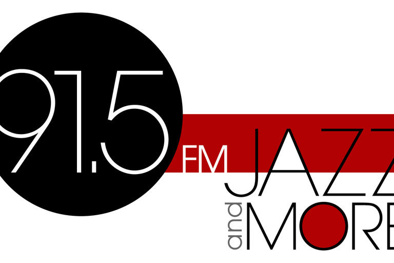 91.5 Jazz and More logo with 91.5 shown in a black circle, with the letters F, M, in white and the words Jazz and More in black letters.