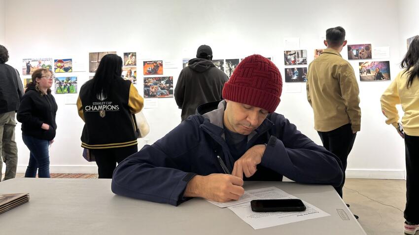 People viewing photographs in an art gallery