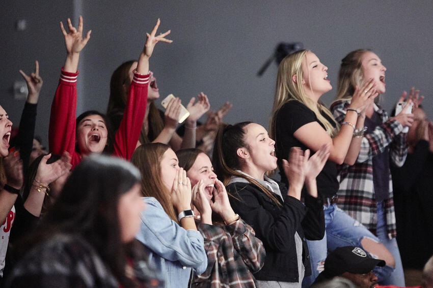 A crowd of students cheering at the Rebel Variety Show.