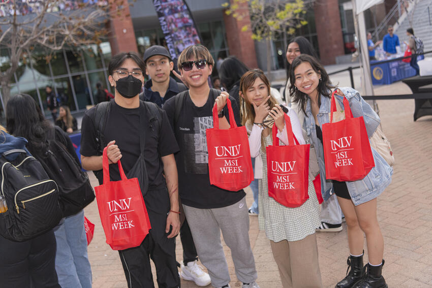 Students posed with the MSI Week swag bags