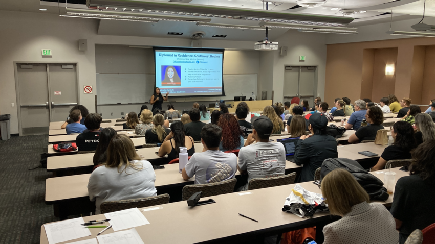 Students in a classroom watching a presentation on a screen