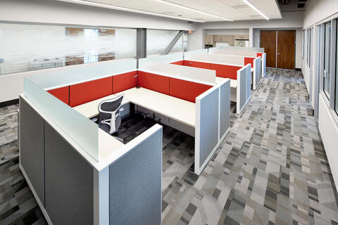 three desk cubicles next to one another