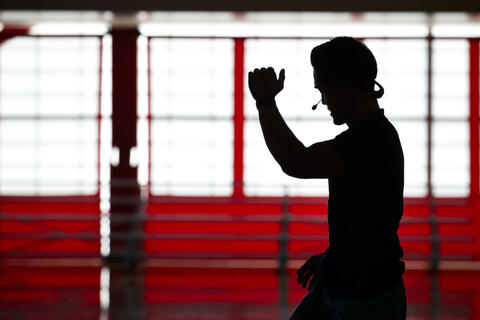 Silhouette of a fitness instructor with a mic